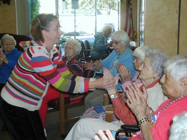 dance instructor leading a group of older adults