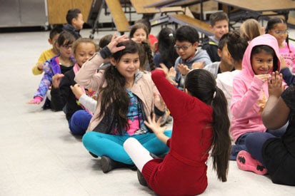 students playing a miming game in pairs
