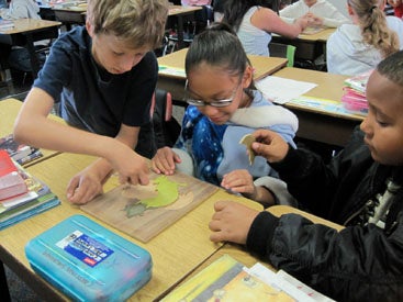 3 students working together to complete a puzzle