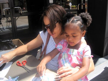 adult and child creating an art project together