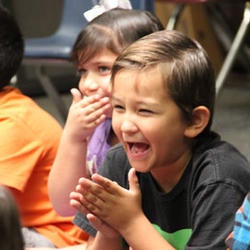 group of students laughing and clapping