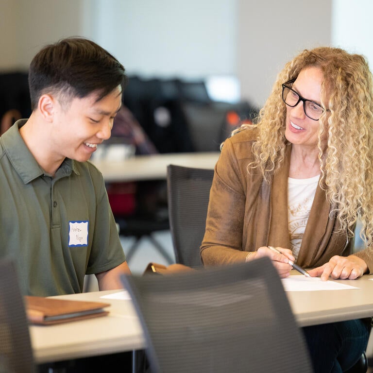 student and professor at table