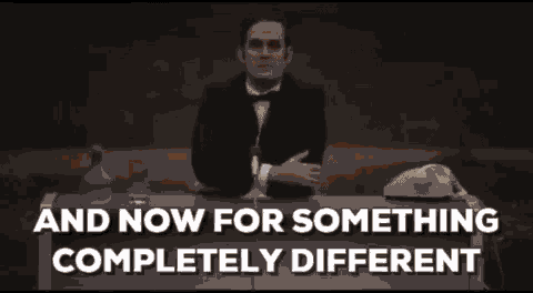 One of the Monty Python actors leaning over a desk as he says "And now for somethign completely different."