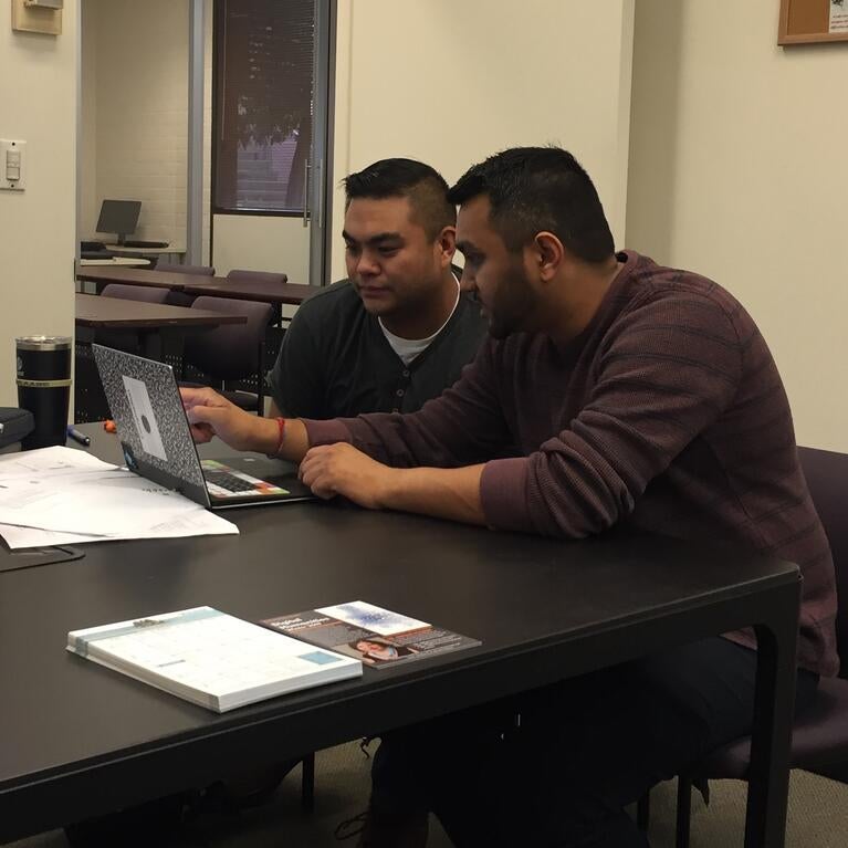 A consultant works with a student in GradQuant