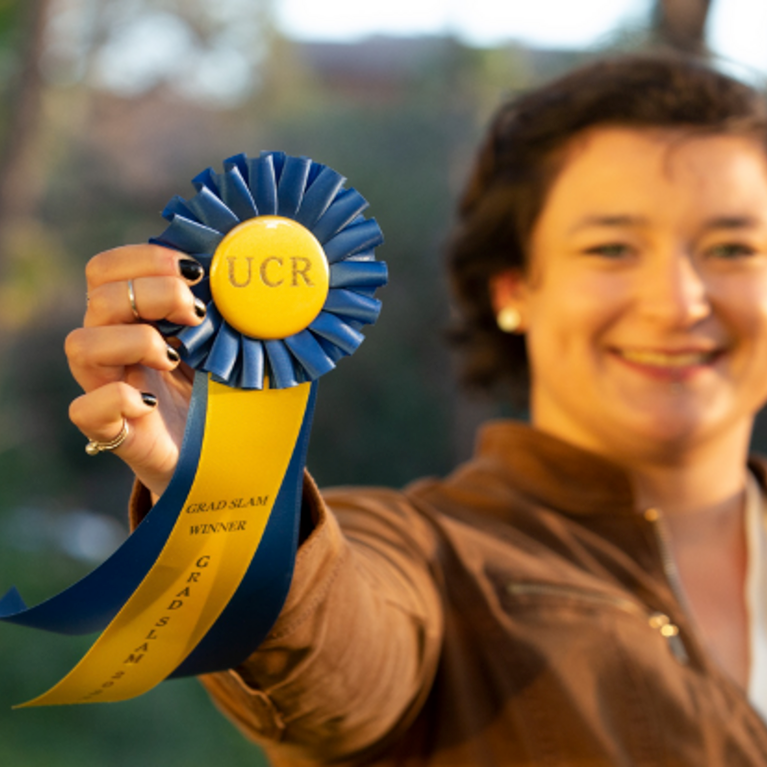 2022 Grad Slam Winner Claire Whitaker holds her grand prize ribbon.