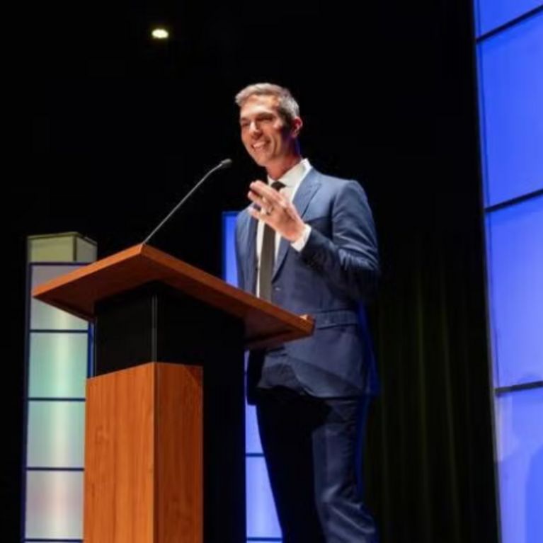 NPR Host Ari Shapiro delivers at Podium delivering Hays Press Enterprise Lecture