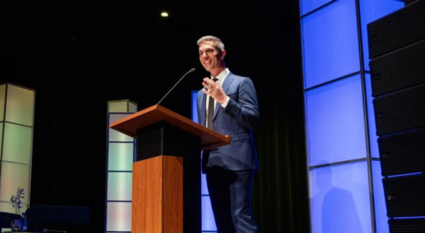 NPR Host Ari Shapiro delivers at Podium delivering Hays Press Enterprise Lecture