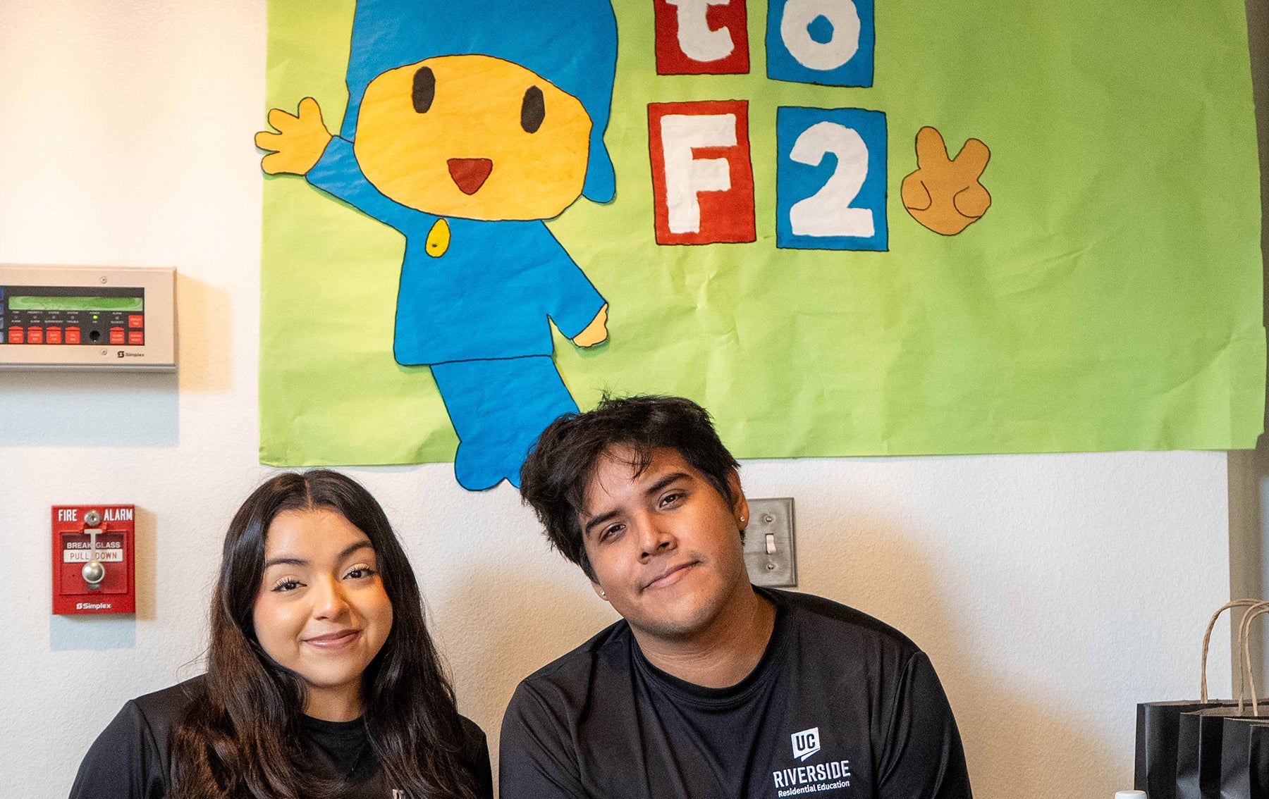 two students at Mundo check-in