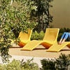 Students enjoy the outdoors in lounge chairs at the North District Campus Apartments.