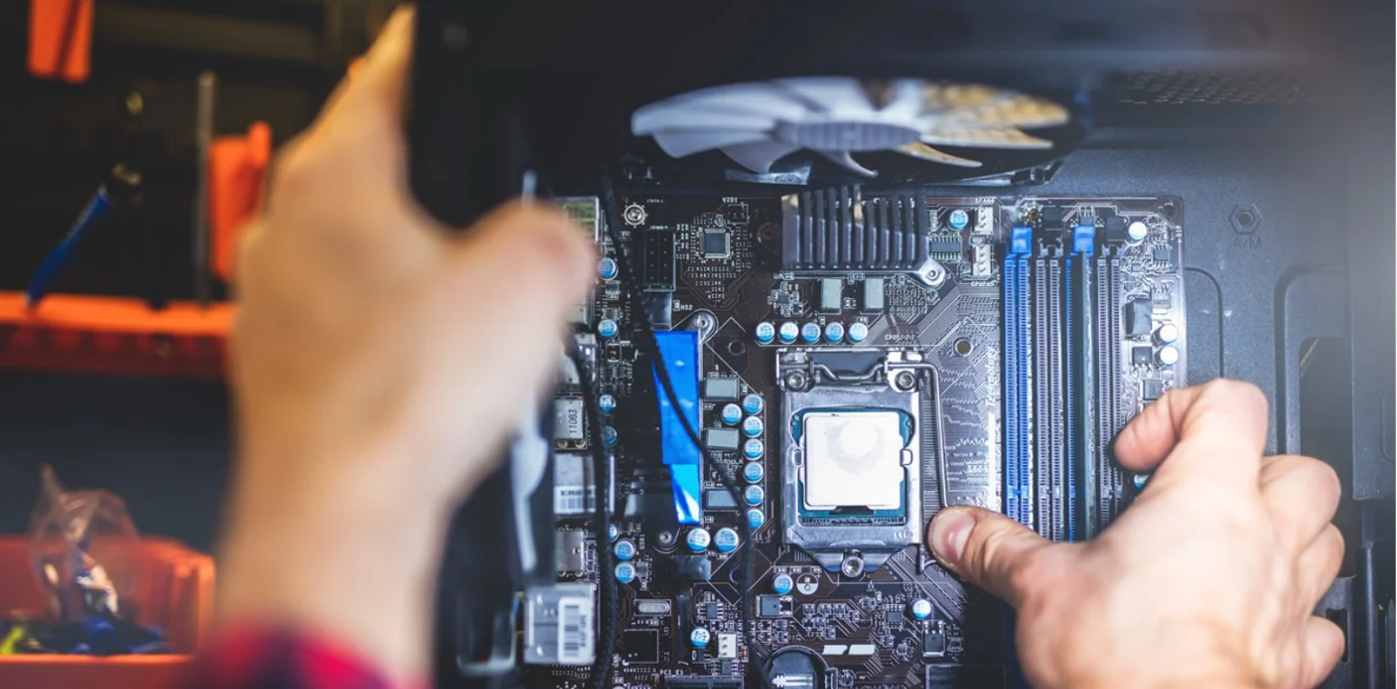 A person opening a computer and looking inside