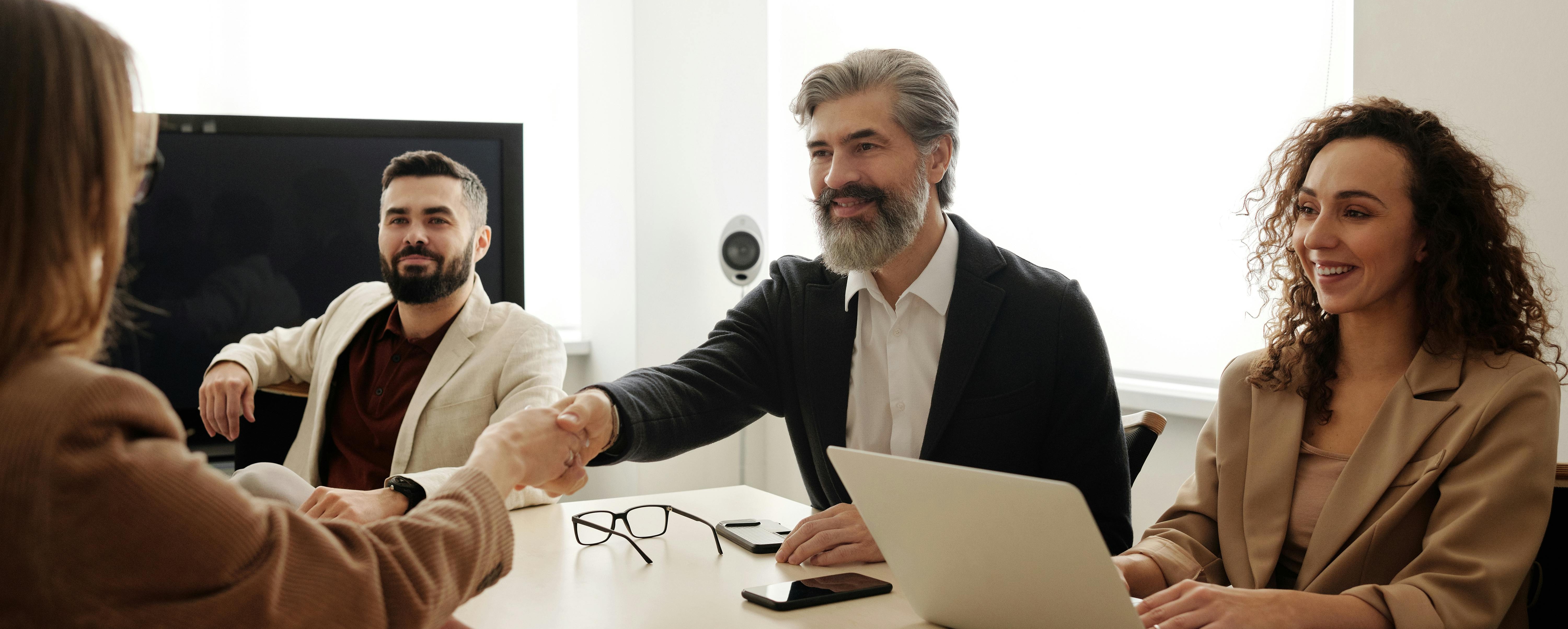 people shaking hands to show management