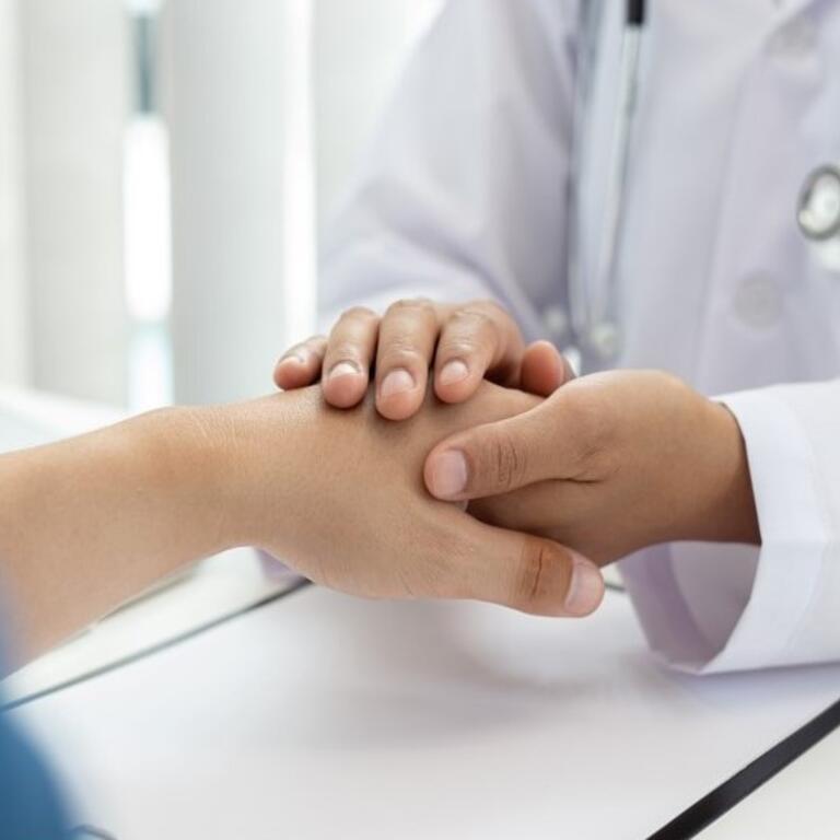 Doctor holding the hand of a patient