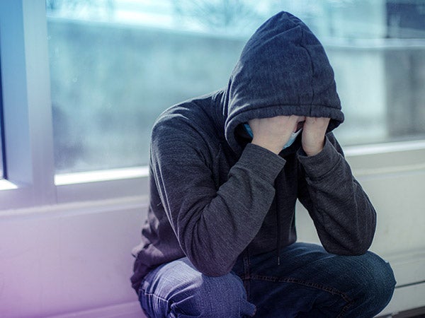 A distressed student sits in contemplation.