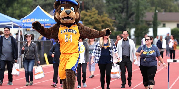 Scotty walks in front of staff and students at UC Walks event.