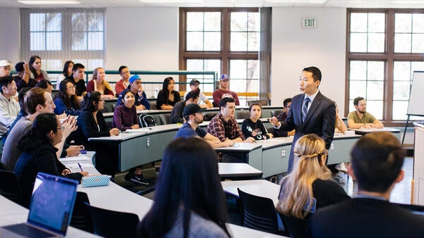 UCR faculty lecturing to class in business building