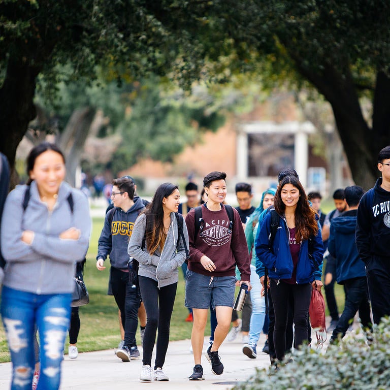 Group of UCR students walking near HUB