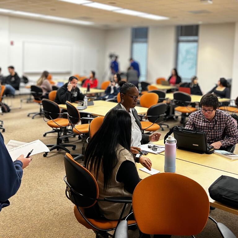Researchers in a room sitting and talking