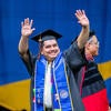 Graduate waving to crowd