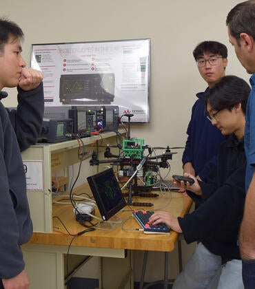 Engineering students work with equipment