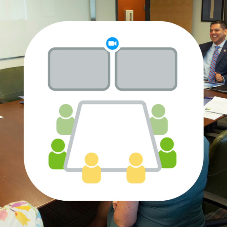 group of people sitting in a conference room