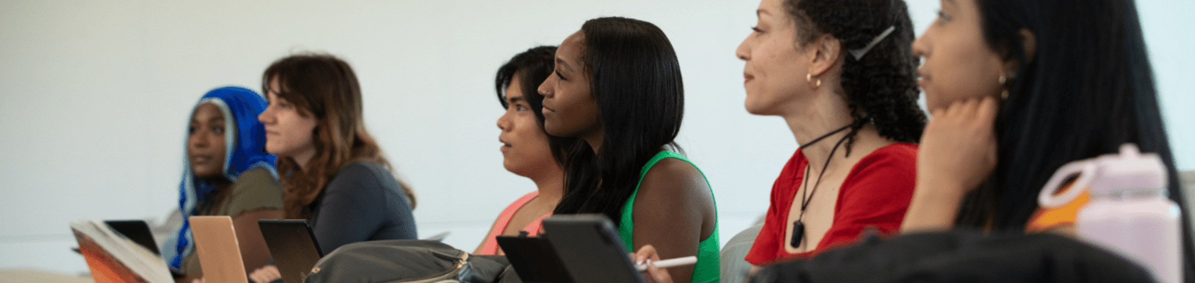 row of engaged students focus on lecturer