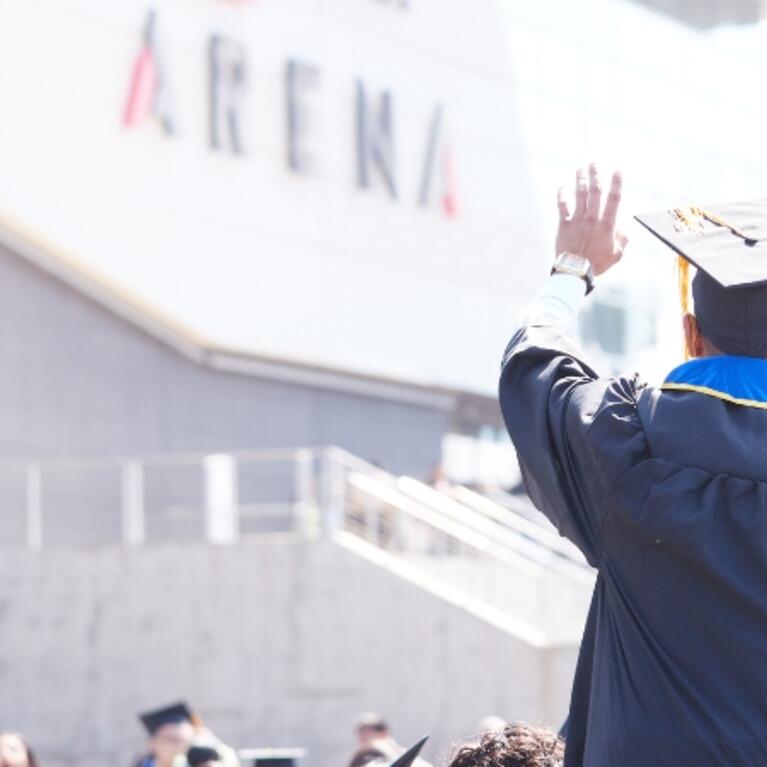Graduating student on someone's shoulders 