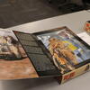 Close-up of a boxed Tuskegee Airmen GI Joe action figure displayed on a table.