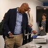 Congressman Shomari Figures reviewing historical photographs from the UCR Library's collection.
