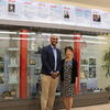 Congressman Shomari Figures and Mihoko Hosoi standing by the Tuskegee exhibit display case.