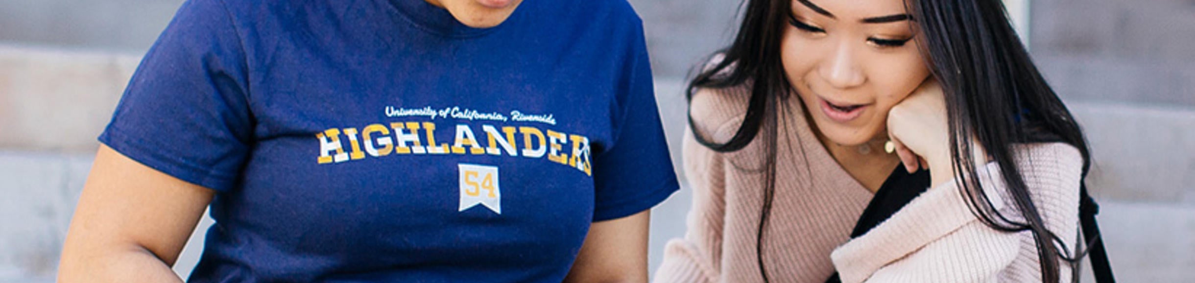 students sitting on steps with laptop (c) UCR