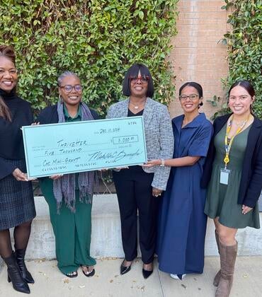 Winner of the Mini grant program being presented an oversized check