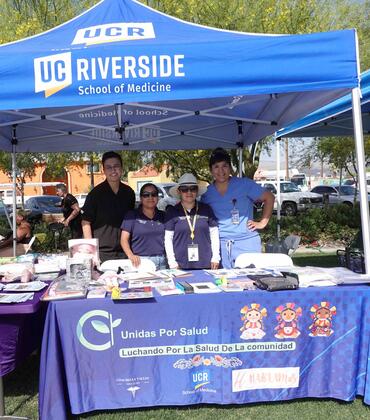 Joslyn Santana, far right, and others tabling for Unidas Por Salud