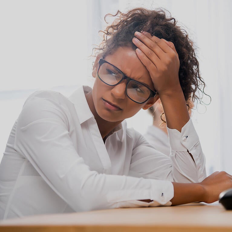student looking stressed while sitting at a desk 