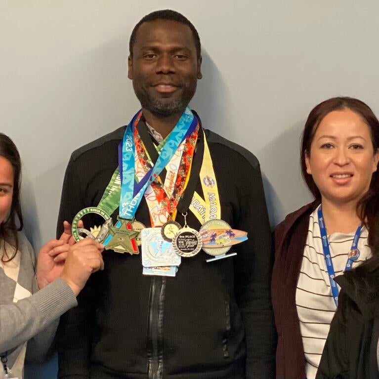 Isaac Owusu-Frimpong with his marathon medals