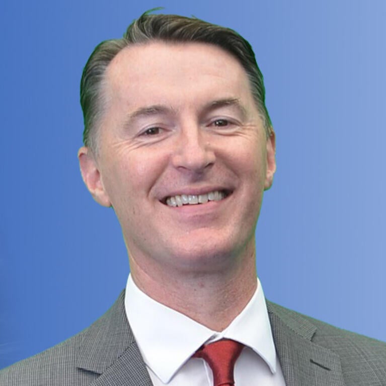 Declan McCole in front of a blue background