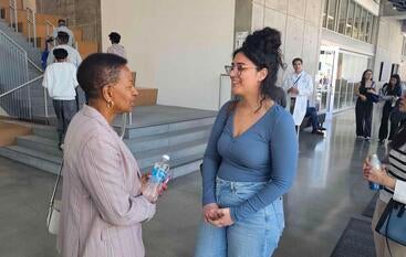 Dean Deas speaking with a woman at Open House 2025