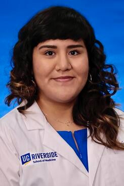 Joslyn Santana in front of a blue background