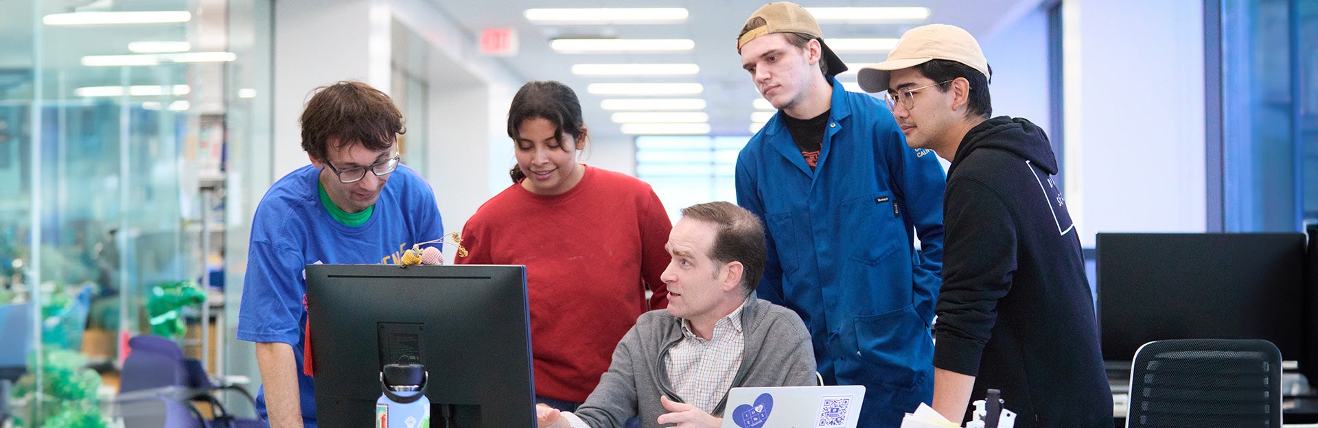 CNAS Students sitting at a table with laptop computers.