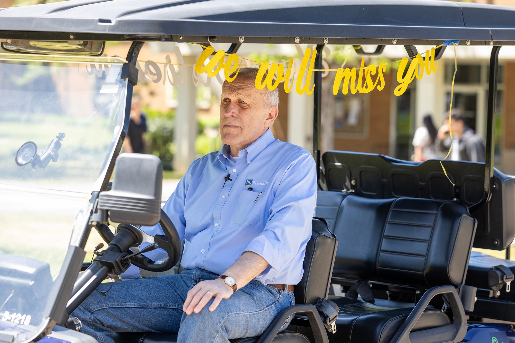 Wilcox rides in a campus golf cart during filming of a final “Wilcox on Wheels” video to say farewell to UCR.