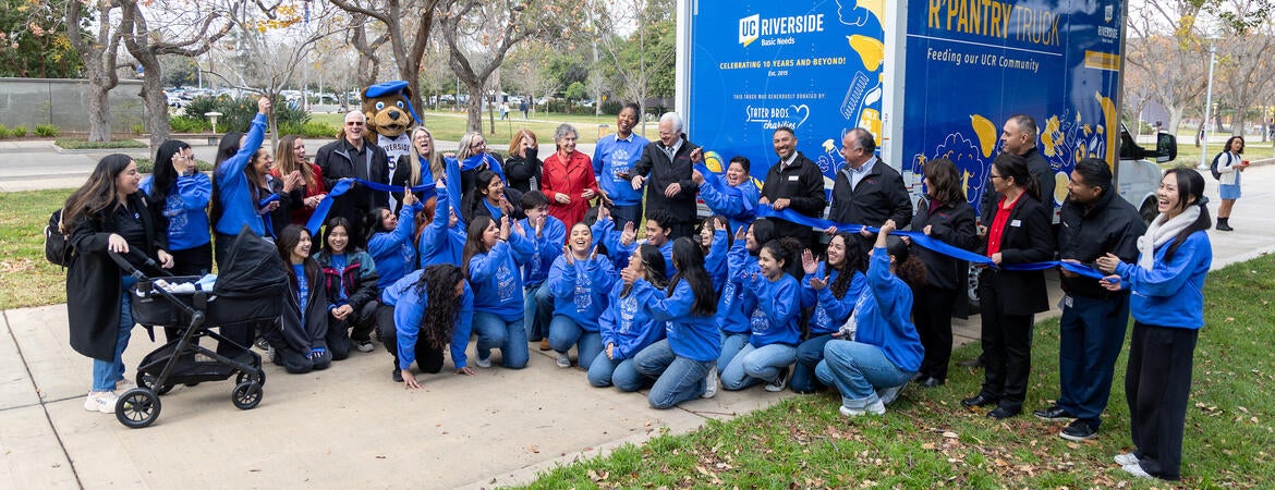 Students, staff, and community cutting ribbon for R'Pantry truck donation.