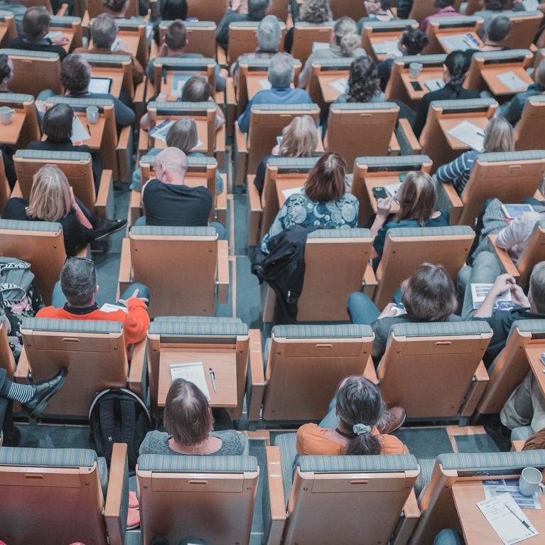 Room filled with people in rows