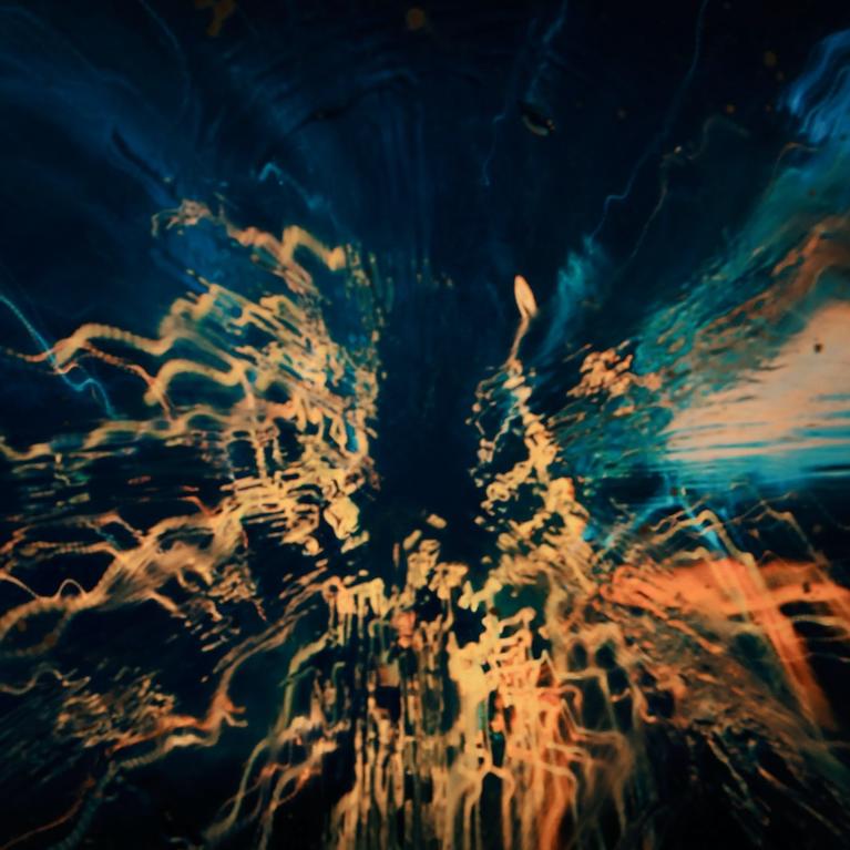 Wiggly light streams against a dark background