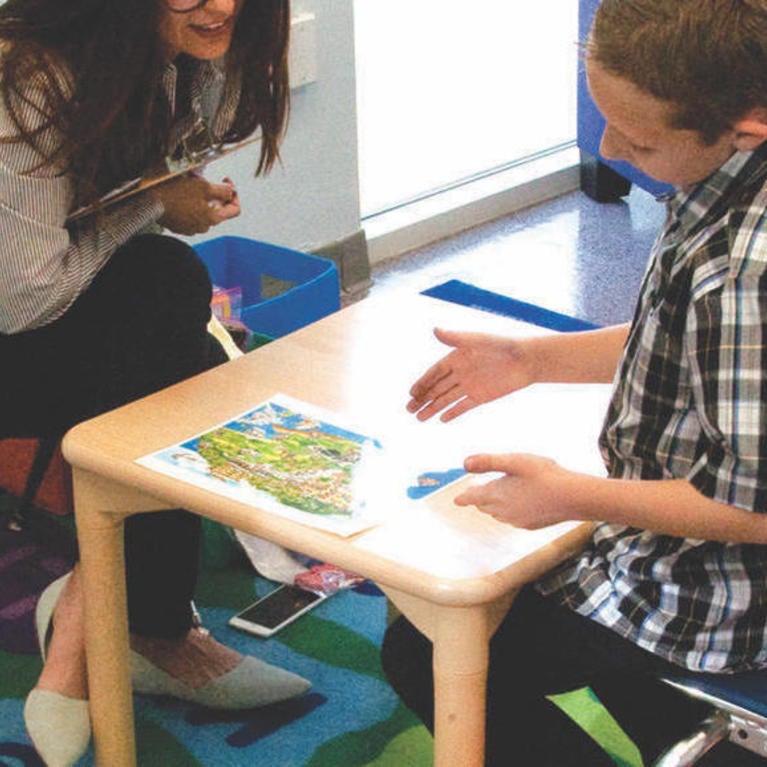A UCR SEARCH Center staffer works with an autistic child