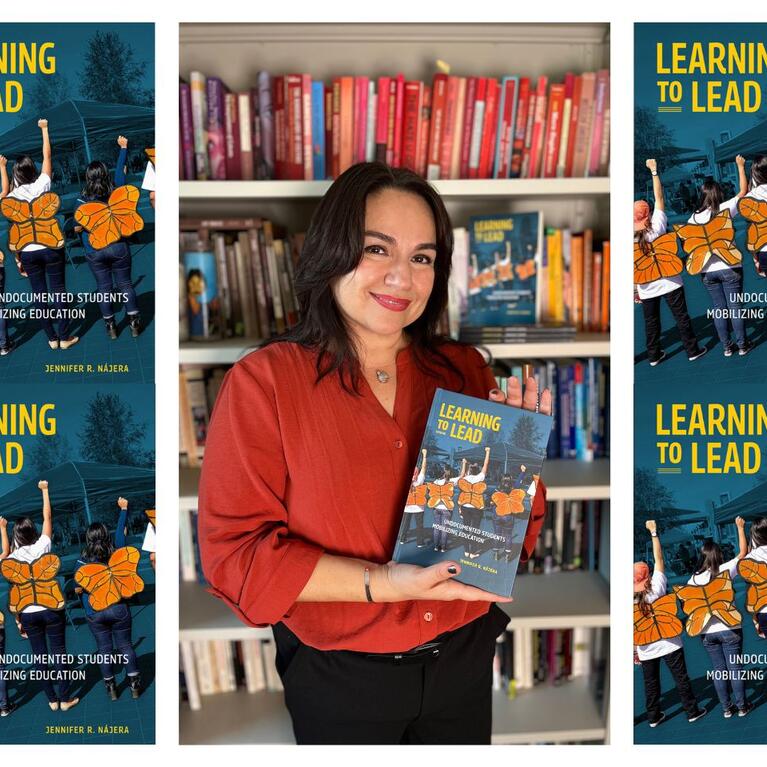 Jennifer Nájera, associate professor of ethnic studies at UC Riverside, holds her new book, Learning to Lead: Undocumented Students Mobilizing Education. (UCR/Sandra Baltazar Martínez)