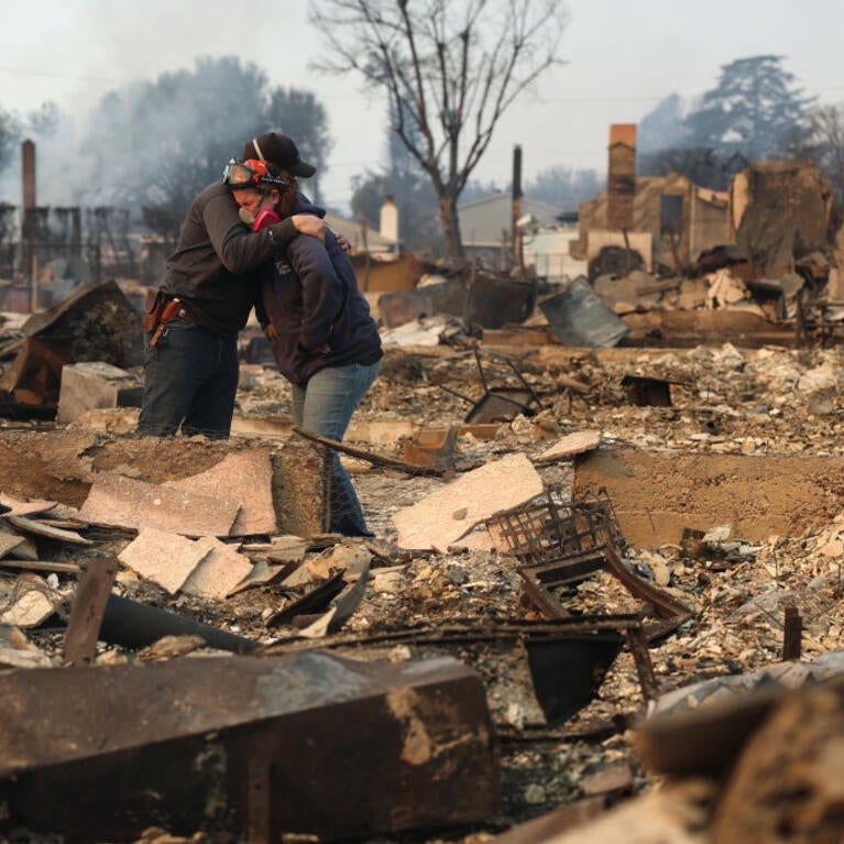 ALTADENA, CALIFORNIA - JANUARY 09: Khaled Fouad (L) and Mimi Laine (R) embrace as they inspect a family member's property that was destroyed by Eaton Fire on January 09, 2025 in Altadena, California. Fueled by intense Santa Ana Winds, the Eaton Fire has grown to over 10,000 acres and has destroyed many homes and businesses. (Photo by Justin Sullivan/Getty Images)