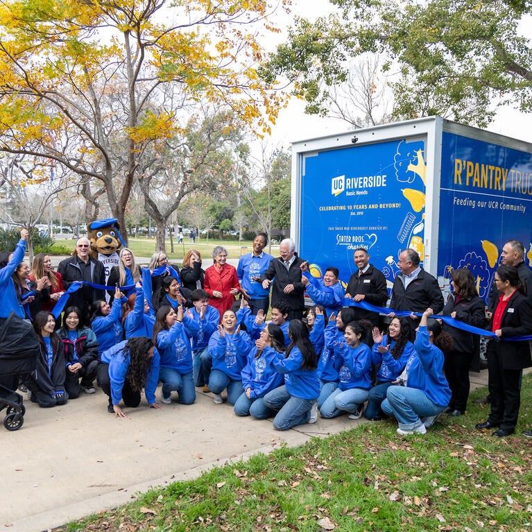 Students, staff, and community cutting ribbon for R'Pantry truck donation.
