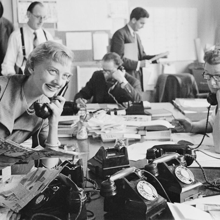 Young woman working with male colleagues in an English PR firm in 1954