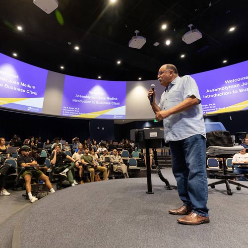 A teacher is lecturing in one of the lecture halls inside the Student Success Center building.