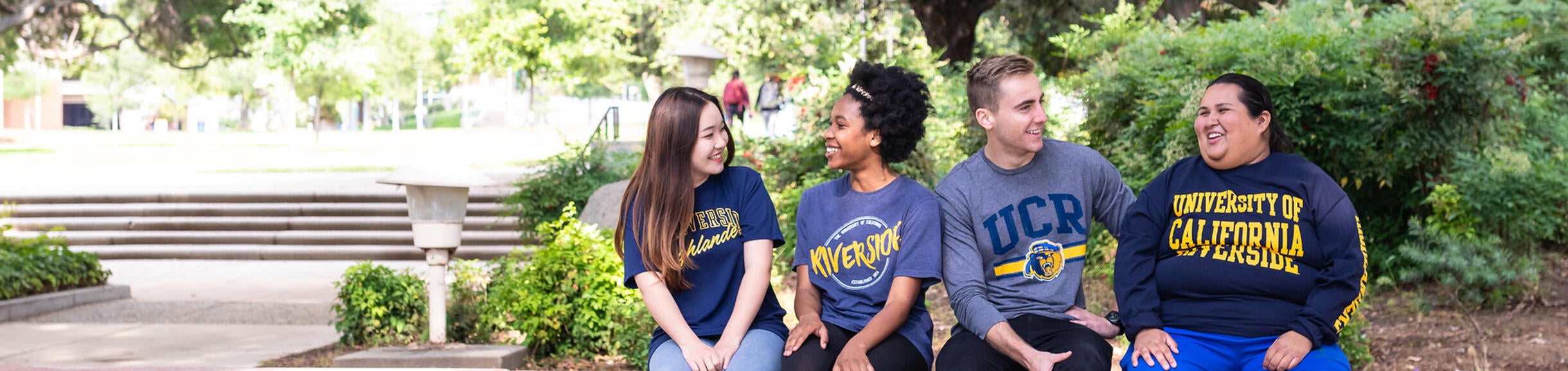 Group of UCR students sitting together near Hinderaker Hall