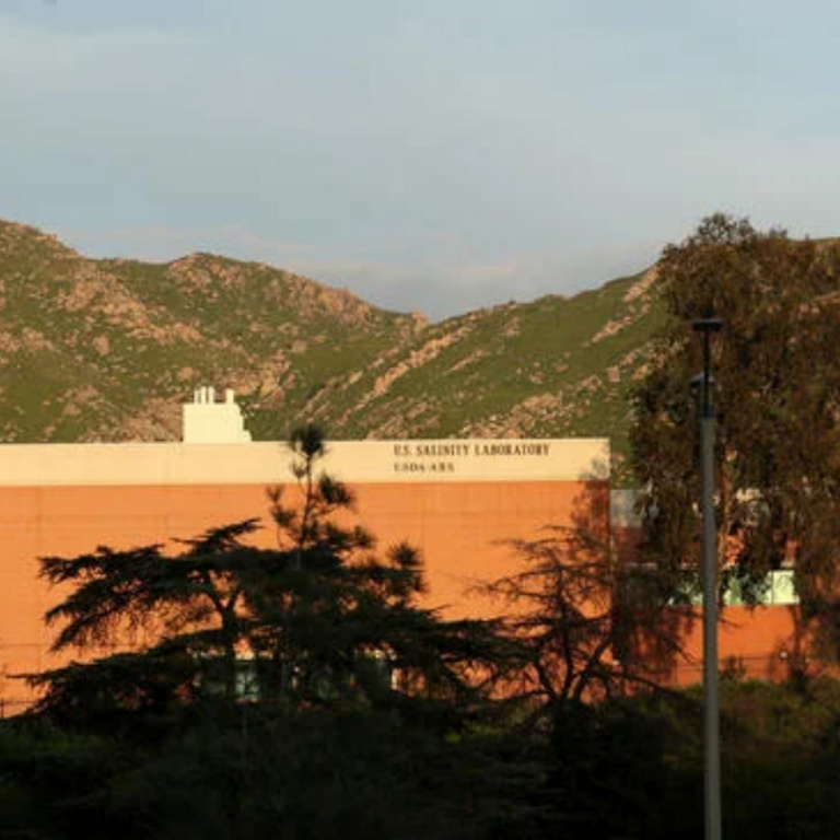 U.S. Salinity Laboratory building with trees and mountains in the background